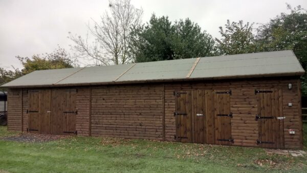 dark wooden large stable block