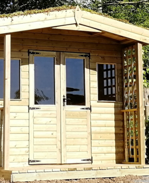 wooden garden room with windows in light wood colour