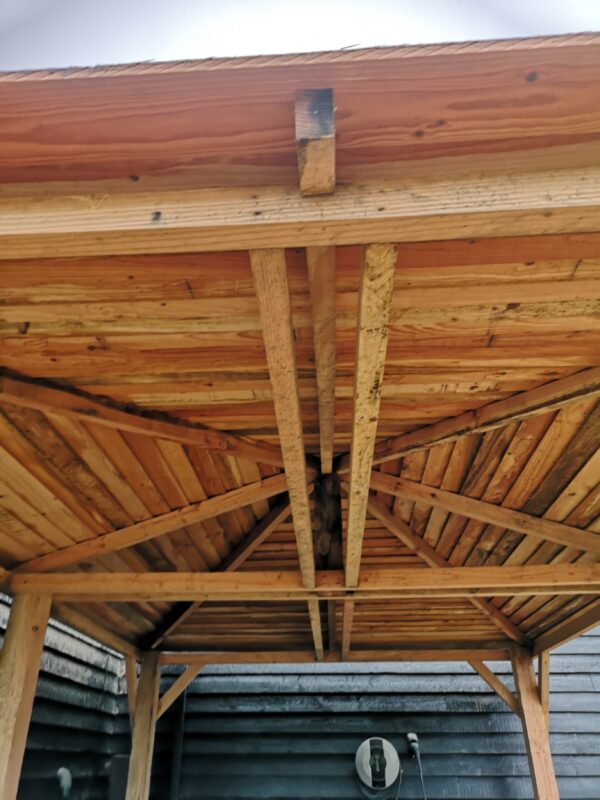 wooden beams forming roof a car port