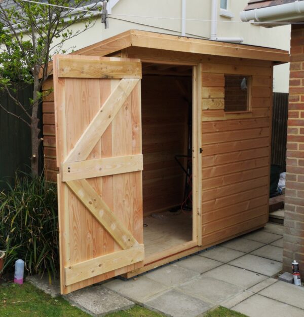rectangle wood shed with pent roof in light coloured wood