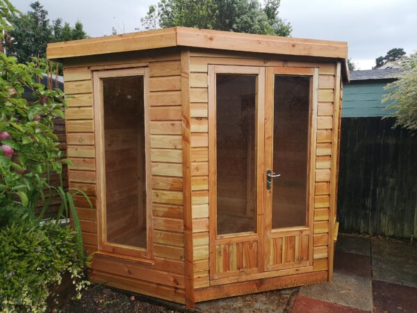 summer house made of wooden with a hexagonal front