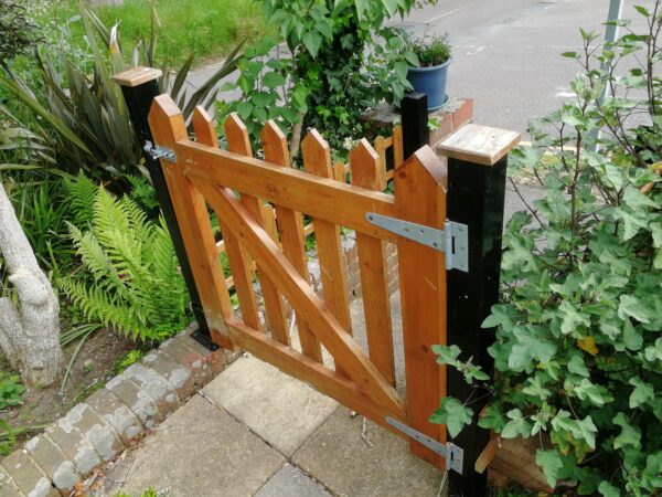 small wooden garden gate in light coloured wood