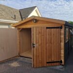 new double doored timber shed with ptich roof, shown from the front with one doors open